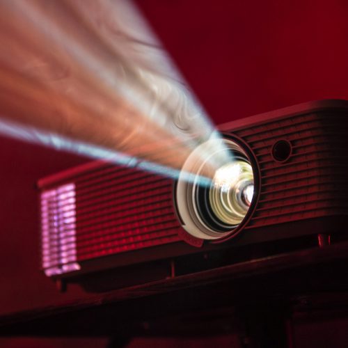 Film projector on a dark red background