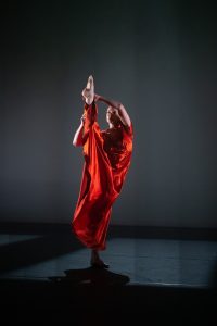 Dancer raising her leg above her head