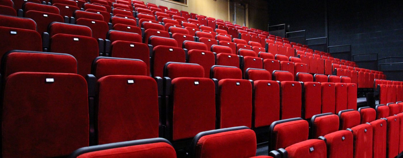 Auditorium with rows of read seats